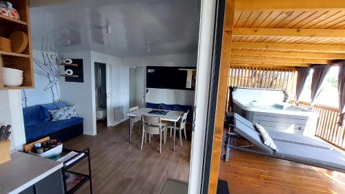 a living room with a kitchen and a dining room at MOBILE HOMES SELCE - ALPE JADRAN MOBIL 641 in Selce