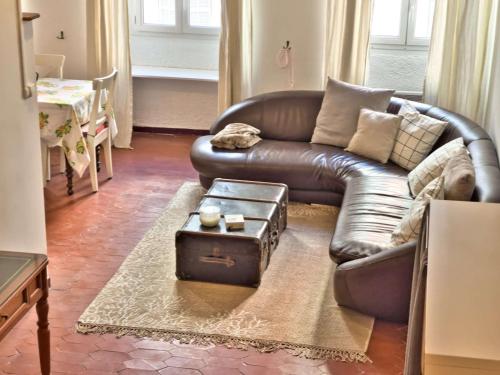 un salon avec un canapé en cuir avec un coffre dans l'établissement Vieux-Port : Appartement Cozy, Calme et Pratique, à Marseille
