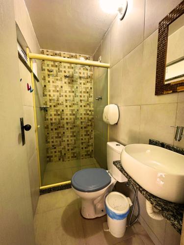 a bathroom with a shower and a toilet and a sink at Mata Virgem Hostel e Pousada in Abraão