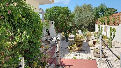 a garden with cacti and a house with a fence at Villa Agnese in Badesi
