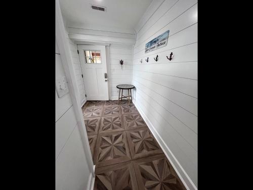 a hallway with white walls and a wooden floor at Boston Commons Penthouse Condo in Myrtle Beach