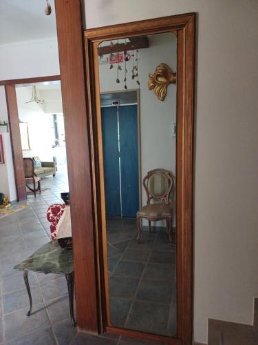 a mirror with a wooden frame in a living room at Hotel Flora in Cesenatico