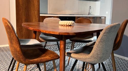 a wooden dining room table with chairs around it at Diana Home - Rooms and Suite in Caserta