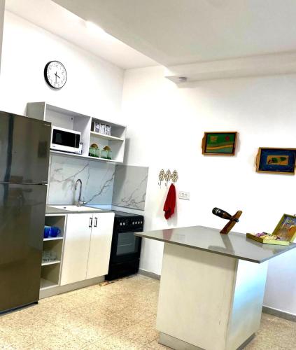 a kitchen with a sink and a counter top at Casa Gilboa Nirvana Suite נופש בגלבוע in Gan Ner