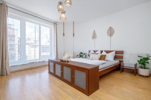 a bedroom with a bed and a large window at Matteo - modern appartment with free parking in Bratislava