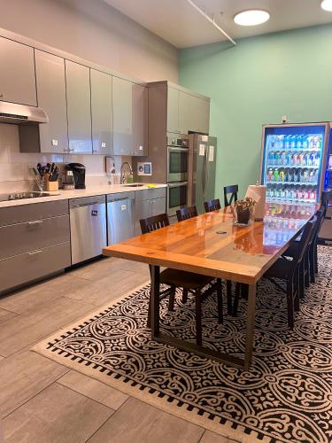 a large kitchen with a wooden table and chairs at The Dorel SF in San Francisco