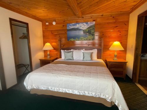 a bedroom with a large bed in a cabin at Lake Crest Inn in Lake George