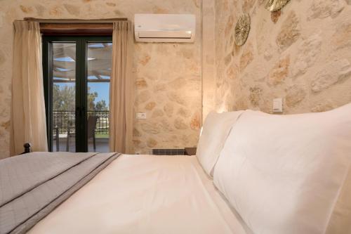 Ένα ή περισσότερα κρεβάτια σε δωμάτιο στο DANDELION stone house