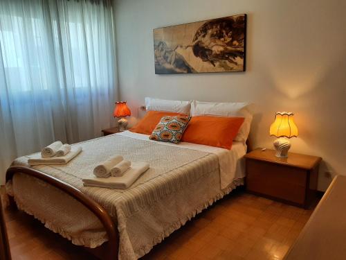 a bedroom with a bed with two towels on it at CASA DI IANA in Mestre
