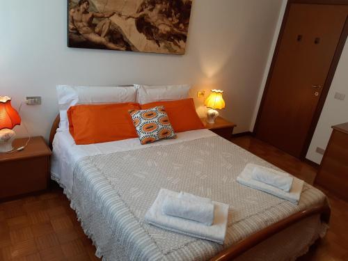 a bedroom with a bed with two towels on it at CASA DI IANA in Mestre