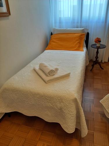 two beds in a room with towels on the bed at CASA DI IANA in Mestre