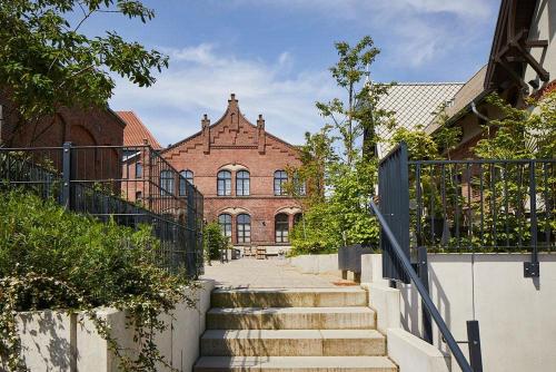 a brick building with stairs in front of a building at Wstay Industrie Charme DELUXE in Steinfurt