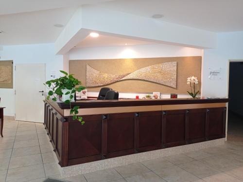 a reception desk in a hospital lobby with flowers at Albergo Etico Cesenatico in Cesenatico