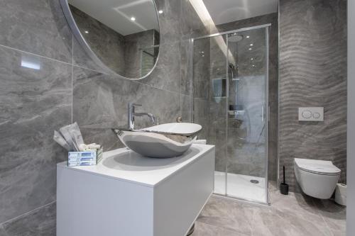 a bathroom with a bowl sink and a mirror at Apartments Taratta in Trogir