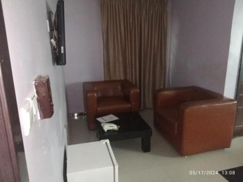 a living room with a couch and a chair at The Residence in Uyo