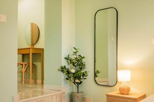 a room with a mirror and a vase with a plant at Kantounata Apartment in Lefkímmi