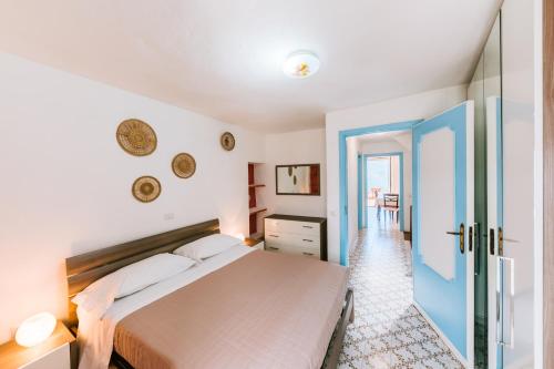 a bedroom with a bed and a blue door at Eden view Ravello houses - Two bedroom in Ravello