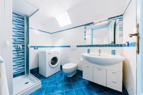 a bathroom with a toilet sink and a washing machine at Sea view - Two bedroom - Ravello houses in Ravello