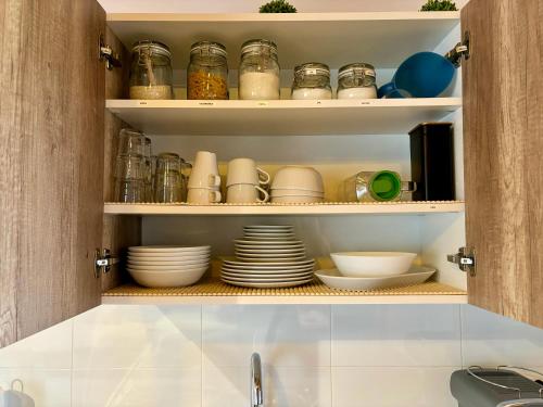 a kitchen pantry with plates and bowls on shelves at Las Casitas de Cerezo 3 in Cerezo de Abajo