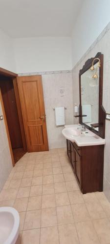 a bathroom with a sink and a mirror and a toilet at La finestra sul mare in Madonna della Pace