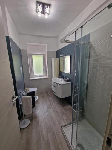 a bathroom with a shower and a sink and a toilet at L'AURORA Locazione Turistica in Sulmona