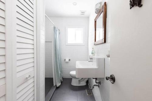 a white bathroom with a sink and a toilet at 3BR Rebecca Lakehouse with Fireplace Wifi and Dock in Oxtongue Lake
