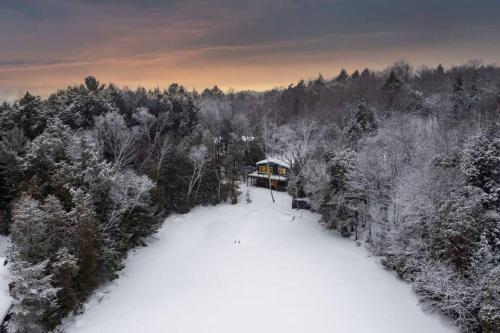 an aerial view of a house in the snow at 3BR Rebecca Lakehouse with Fireplace Wifi and Dock in Oxtongue Lake