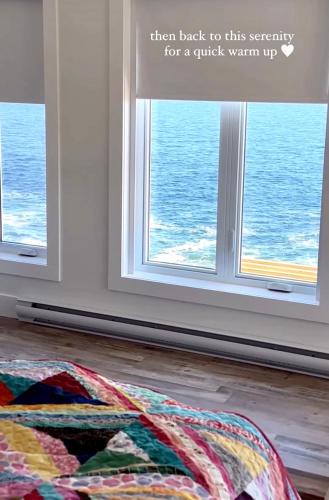 a quilt laying on the floor in front of a window at The View suites and breakfast in Triton, Newfoundland in Pilleyʼs Island