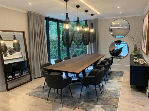 a dining room with a large wooden table and chairs at Beyond Paradise in Knysna