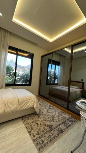 a bedroom with two beds and a large mirror at Smart luxury apartment 3bedrooms in Riyadh