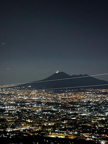 a view of a city at night with a mountain at Cerchia Apartments in Corbara