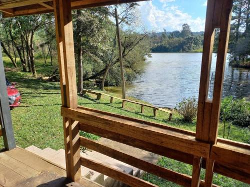 a view of a lake from the porch of a cabin at Cabana de pesca e lazer Represa Usina Mafra sc in Mafra