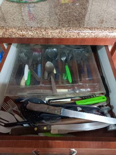 a drawer full of utensils sitting on a counter at Cabana de pesca e lazer Represa Usina Mafra sc in Mafra