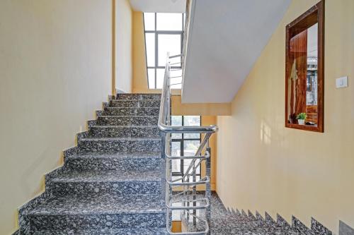 a staircase in a building with a metal handrail at Hotel Virat Inn in Bangalore