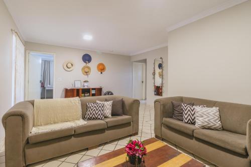 a living room with two couches and a table at Casa temporada Condomínio Clube, até 10 pessoas. in Caldas Novas