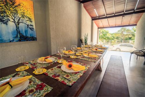 a long table with plates and glasses on it at Casa temporada Condomínio Clube, até 10 pessoas. in Caldas Novas