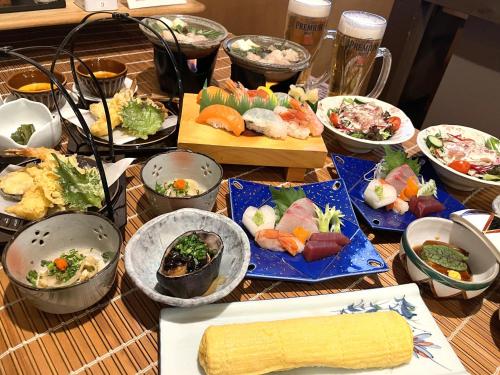 a table topped with lots of different types of food at Plaza Hotel Nogata in Nōgata