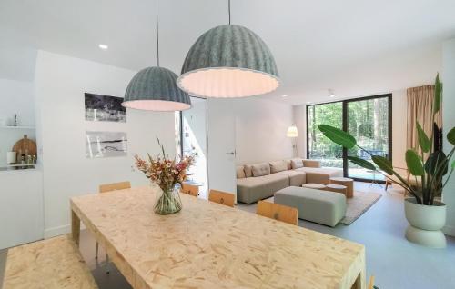 a living room with a table and a couch at Lovely Home In Bennekom With Sauna in Bennekom