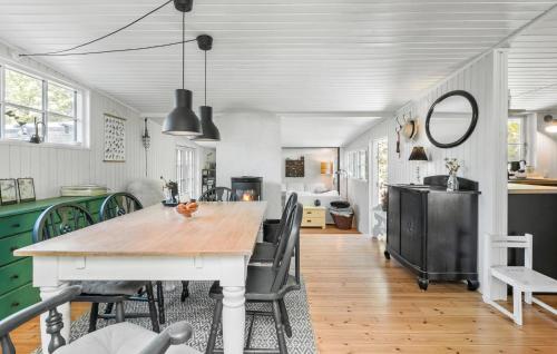 a kitchen with a table and chairs in a room at Pet Friendly Home In Melby With Wifi in Melby