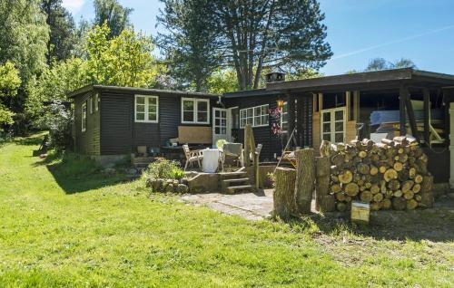 a log cabin with a porch and a yard at Pet Friendly Home In Melby With Wifi in Melby