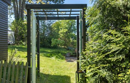 an open door to a yard with a fence at Pet Friendly Home In Melby With Wifi in Melby