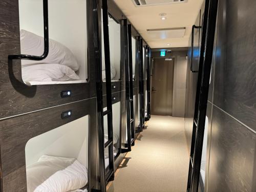 a row of bunk beds in an rv at カプセルホテル鈴森屋 Capsule Hotel Suzumoriya in Tokyo