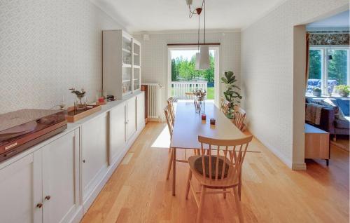 a kitchen and dining room with a table and chairs at Gorgeous Home In Lönsboda With Wifi in Lönsboda