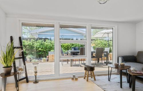 a living room with a sliding glass door with a patio at 3 Bedroom Gorgeous Home In Børkop in Børkop