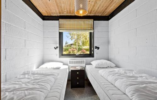 2 camas individuales en una habitación con ventana en Amazing Home In Svendborg With Kitchen, en Vemmenæs