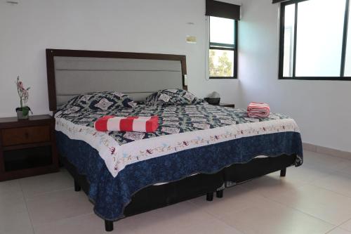 a bedroom with a bed with a quilt on it at Villas Miland - San Benito Beach in San Benito