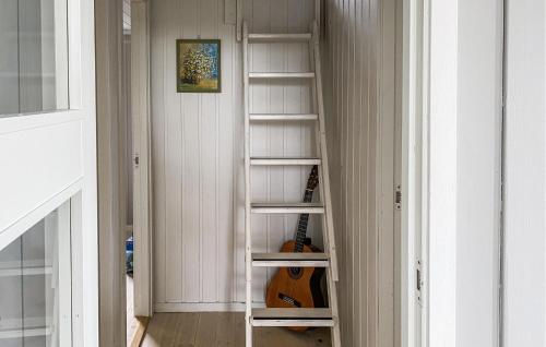 a book shelf in a hallway with a guitar at Amazing Home In Stranda With Jacuzzi in Stranda
