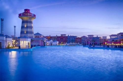 a lighthouse on the water in front of a city at Porto Sharm elsheikh-Aqua park view in Sharm El Sheikh