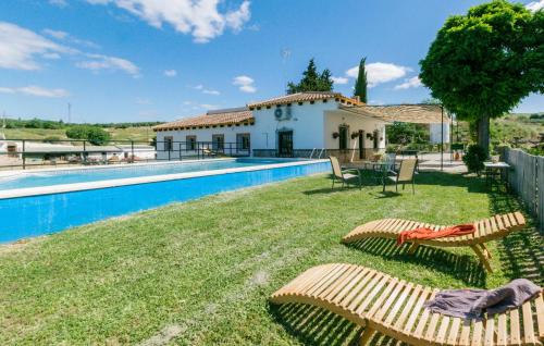 a villa with a swimming pool and a house at Nice Home In La Puebla De Los Infan in La Puebla de los Infantes