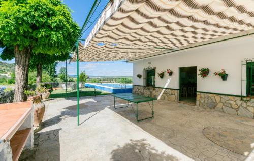 an outdoor patio with a table and a swimming pool at Nice Home In La Puebla De Los Infan in La Puebla de los Infantes
